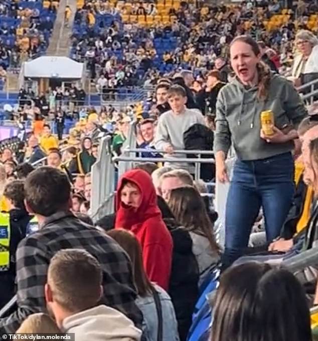 The man in the grey flannel shirt on the left had stopped the pitch intruder before boos rang out through the stadium and this angry woman gave him a service