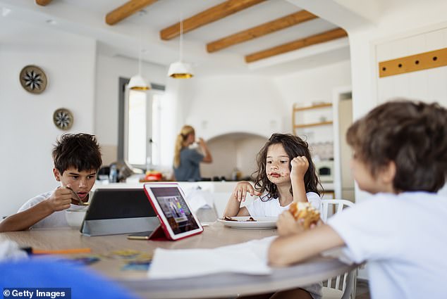 The report from pub chain Hungry Horse found that the average family in the UK only eats together three times a week, with 7 per cent never sitting down to eat at the same time. Only 19 per cent of the 2,000 parents surveyed ate together every day (file image)