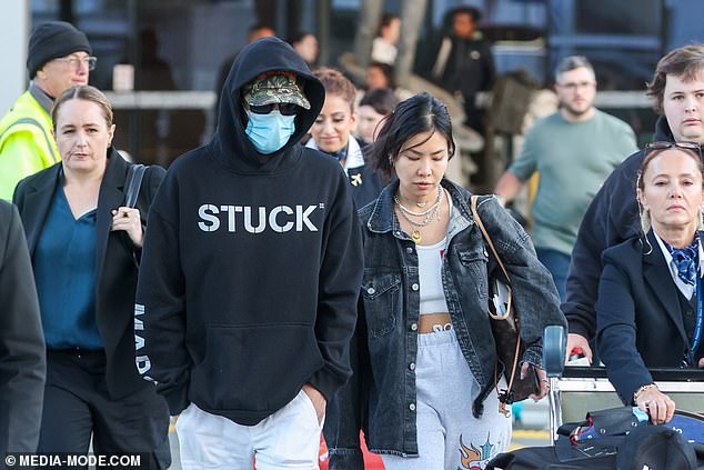 The Suicide Squad star was accompanied by an unidentified woman as he covered his face with a mask, dark sunglasses and a camouflage hat that was further hidden by his hood