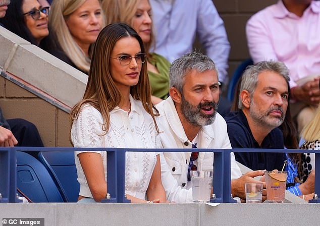 The 43-year-old model completed her courtside look with a diamond necklace and ombre sunglasses