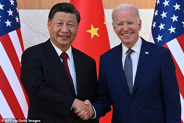 US President Joe Biden (R) and Chinese President Xi Jinping (L) shake hands during their meeting on the sidelines of the G20 summit