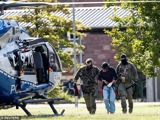 A 26-year-old Syrian man, suspected of the attack in Solingen, is escorted by the police on August 25