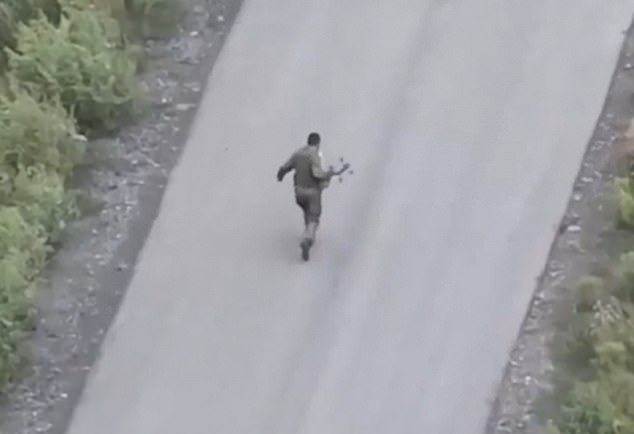 The Putin fighter can be seen desperately running for his life as he is chased by the UAV