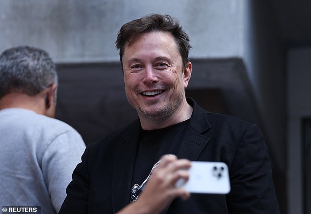 The tech mogul smiled for the camera in a black shirt and blazer