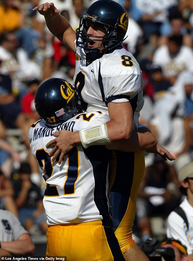 Chris Manderino, who later played in the NFL, lifts the quarterback into the air