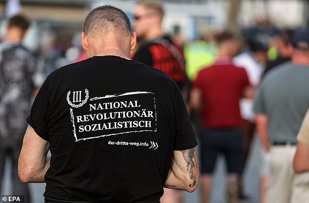 A far-right supporter wearing a shirt of the far-right small party Der Dritte Weg (The Third Way) takes part in a protest in Solingen on August 26