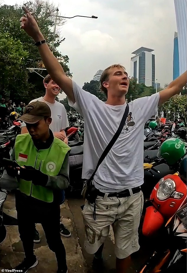 Benjamin James Lovell and his friend Benjamin Thomas Sloan got caught up in the crowd - even jokingly donning headbands and cheering along with the locals