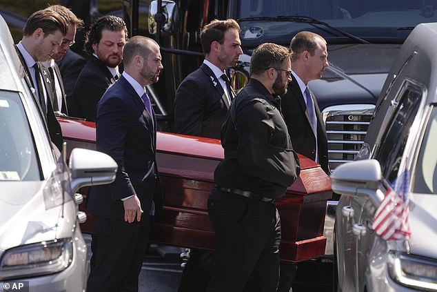 A group of family and friends carry Matthew's casket to the funeral service