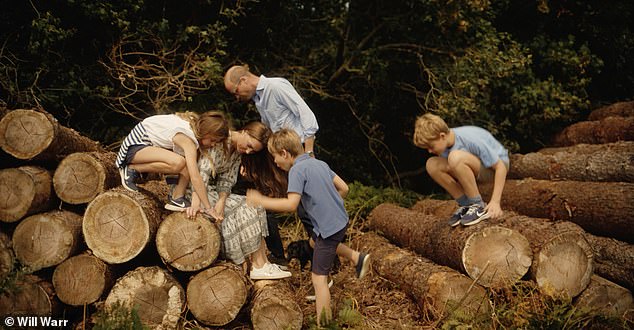 The Cambridges and their three children clamber over logs near their Norfolk home