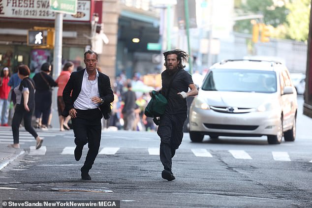 Another photo shows the duo running down the street, with Jason carrying a large bag as they are chased by a car.