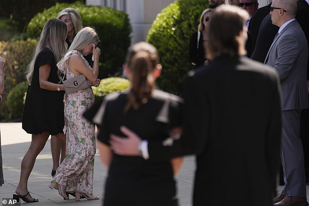 Matthew's wife Madeline, who is expected to give birth to their son Tripp in late December, is seen entering the church on Monday for her husband and brother-in-law's service