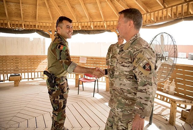 Afghan General Sami Sadat (left) greets U.S. General Scott Miller, the head of the U.S.-led coalition in Afghanistan, in southern Helmand province in April 2021. 