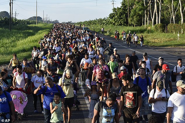 Migrants walk along the highway through Suchiate, in the state of Chiapas in southern Mexico.