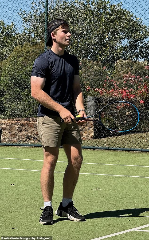 Stepping out of his Australia Zoo uniform, the conservationist wore a black T-shirt that highlighted his muscular arms - sending fans wild over his buff physique