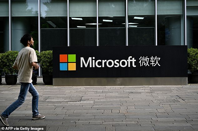 A man walks past Microsoft's local headquarters in Beijing on July 20, 2021, the day after the US accused Beijing of carrying out the cyberattack on Microsoft and charged four Chinese nationals for the 