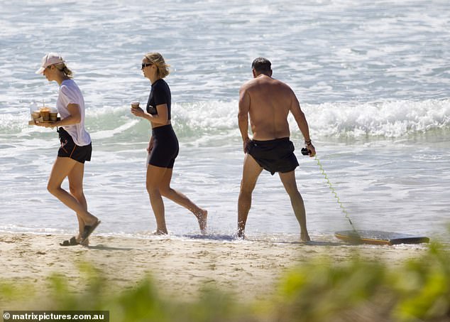 The Today presenter looked in top condition in a pair of football shorts as he shamelessly rocked his dad bod along the sandy shore, dragging a boogie board behind him