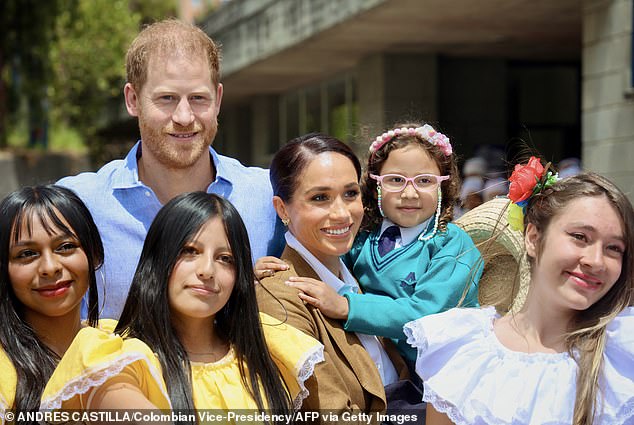 The Duke and Duchess of Sussex with students at La Giralda School in Bogota on August 16