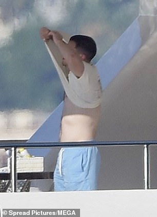 He took off his white T-shirt before entering the water