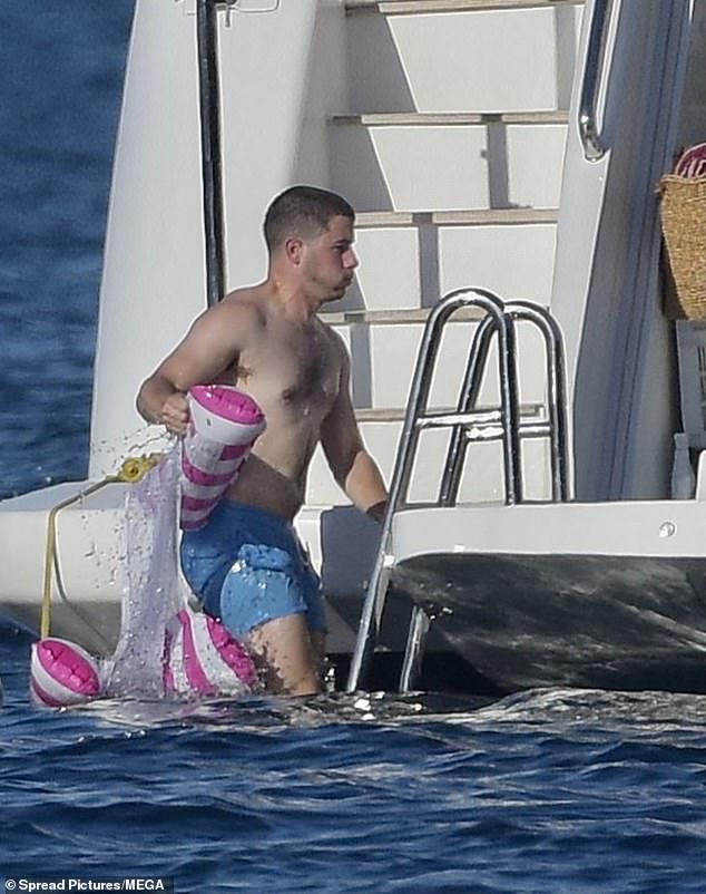 After enjoying a relaxing float in the sea, he was spotted climbing back onto the yacht