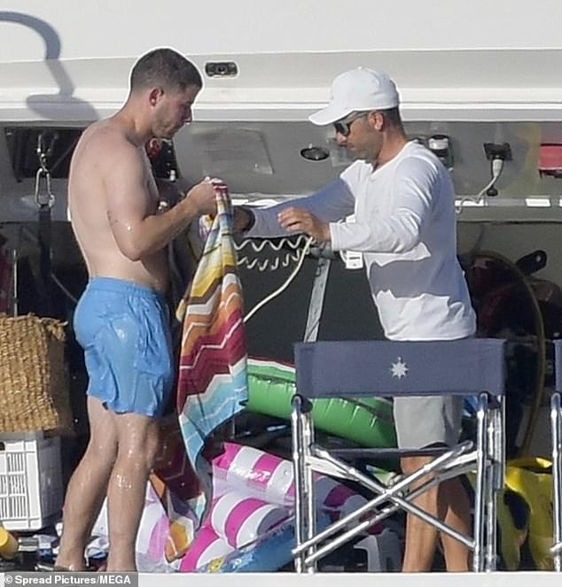 After climbing back aboard the yacht, he was helped with a towel