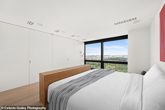 One of the three bedrooms is pictured here with a postcard view of Central Park