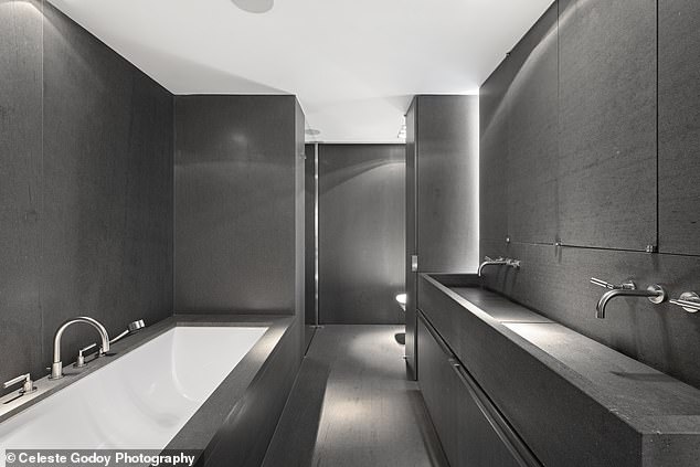 Here you can see one of the three sleek, stone-clad bathrooms