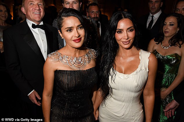 Kim stunned on the red carpet in a plunging white latex dress and was seen mingling with Salma Hayek