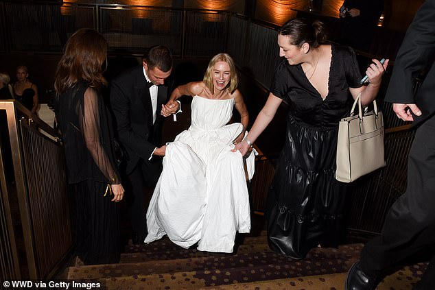 When she arrived, Naomi needed a helping hand to get up the stairs because of the flowing skirt of her dress