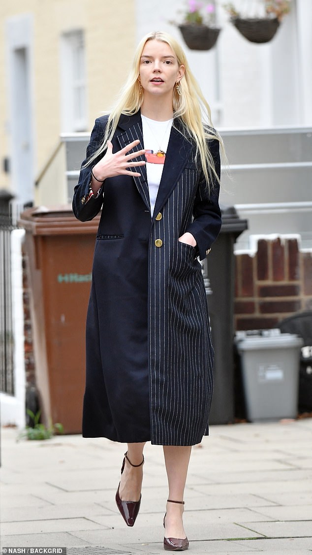 Her T-shirt had a simple image of a car on the front and she opted for a long pendant necklace