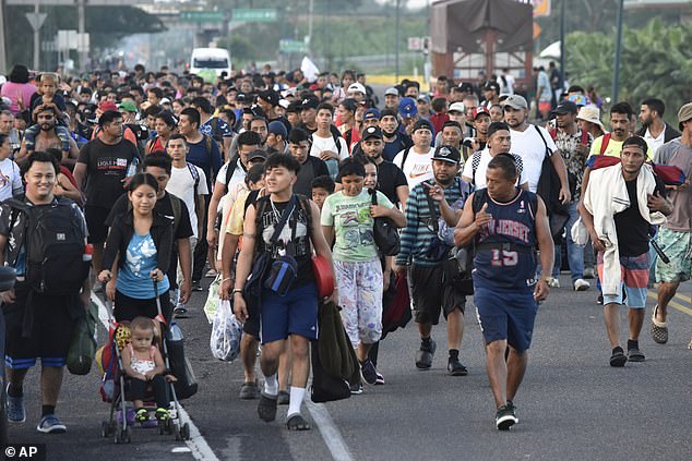 Migrants walk along the highway through Suchiate, in the southern Mexican state of Chiapas, as they travel north toward the US border.