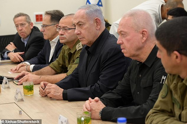 Israeli Prime Minister Benjamin Netanyahu (center) and Israeli Defense Minister Yoav Gallant (2nd from right) are pictured at a military base in Tel Aviv, Israel, August 25, 2024.