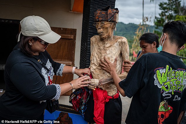 Every four years, the Toraja people dig up the graves of their ancestors to carefully care for their bodies