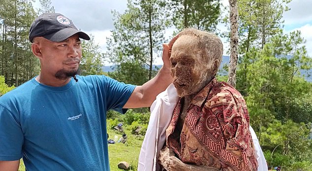 Villagers were seen posing with their dead ancestors, who had dry, papery skin after spending years in the ground