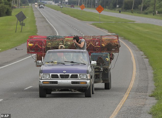 Crab hunters move their traps inside the levee protection system in Lower St. Bernard Parish, Louisiana on Monday.