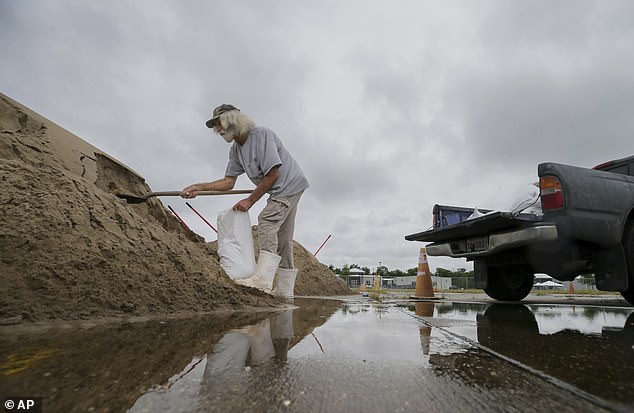 Bubby Longo fills sandbags in a Kmart and Sears parking lot in Chalmette, Louisiana on Monday