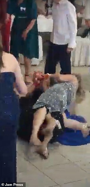 The trio, dressed in silver, blue and black dresses, were seen rolling on the floor, dragging each other across the room in a desperate attempt to get the bouquet.