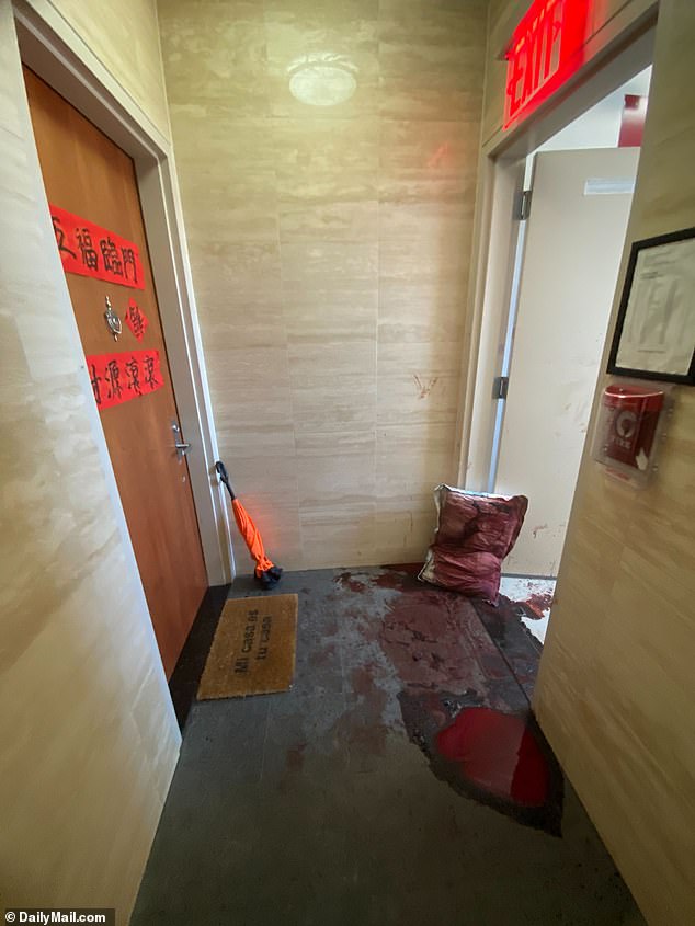 Pictured: The blood-soaked hallway of the Lower East Side apartment building