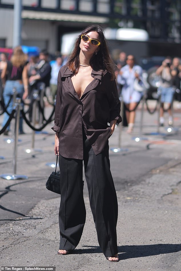 She teamed her look with baggy trousers and sandals, while carrying a designer bag