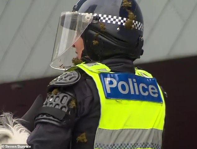 Officers were seen with feces stuck to their helmets and uniforms as they attempted to control the crowd