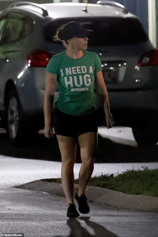 Anthony was photographed wearing tight, dark shorts, a green T-shirt that read 