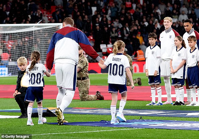 Kane walked out with his kids who wore shirts with 'Daddy 100' on the back to honor the special occasion