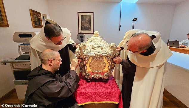 It is expected to take several months before doctors and scientists receive the results of their analysis from a laboratory in Italy. Pictured: The silver marble coffin of Saint Teresa of Avila