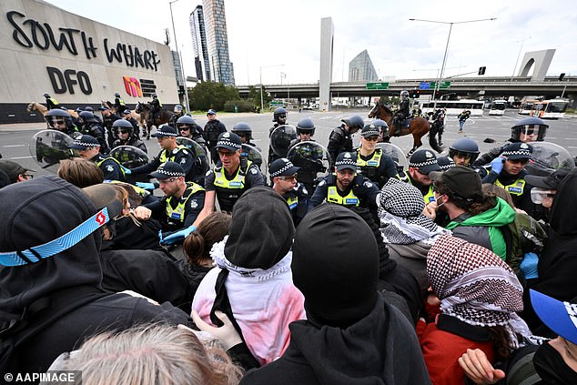 Pictured: Anti-war protesters attempt to break through police barricades on Wednesday