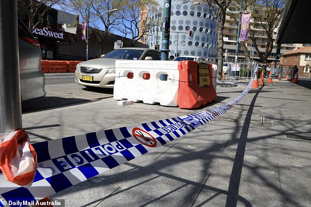 Police tape was still stretched across the sidewalk on Macquarie Street on Monday