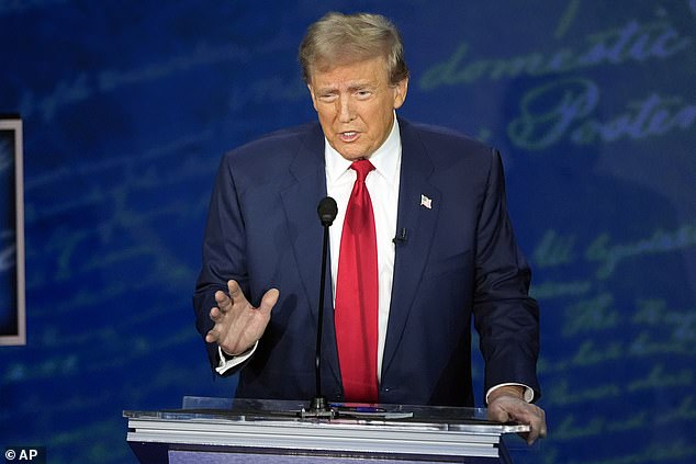 Republican presidential candidate former President Donald Trump speaks with Democratic presidential candidate Vice President Kamala Harris during a presidential debate