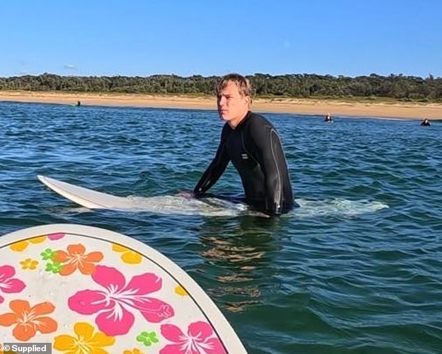 The student (pictured) said he thought the door would land in the surf, but as he got closer, he and the other surfers thought it would land on a fisherman.