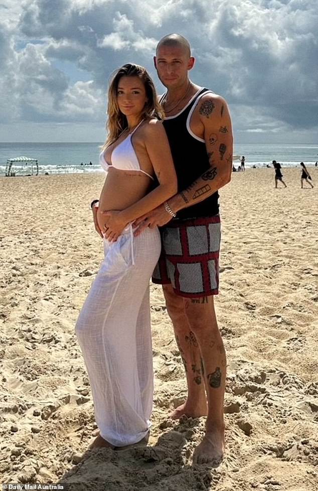 Adorable photos shared with the Daily Mail show Daisy's baby bump as she posed on the beach in a white bikini alongside her smitten partner Preview