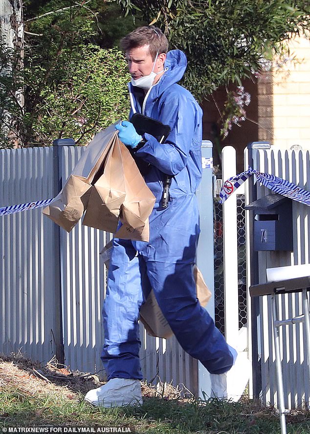 Forensic experts remove bags full of evidence from house