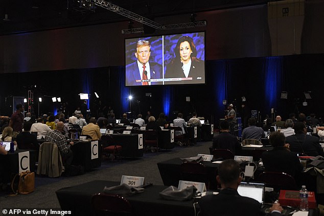 Journalists and members of the media watch from the spin room as U.S. Vice President and Democratic presidential candidate Kamala Harris and former U.S. President and Republican presidential candidate Donald Trump participate in a presidential debate at the National Constitution Center in Philadelphia.