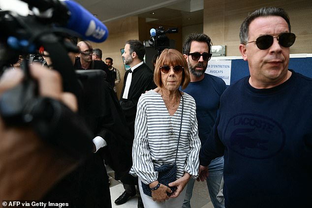 Gisele Pelicot faces reporters as she leaves the courtroom, flanked by her sons Florian (back) and David (right), after attending a hearing in the trial of her former partner Dominique Pelicot, who is accused of drugging her for nearly a decade and inviting strangers to rape her at their home in Mazan, a small town in the south of France, at the courthouse in Avignon, on Monday